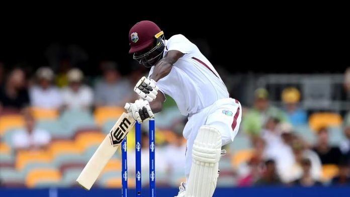 West Indies debutant Kevin Sinclair lets go of his backflip celebration following his 1st Test wicket against Australia