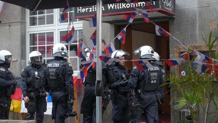 Fans of England and Serbia engage in a violent brawl, causing chaos to break out